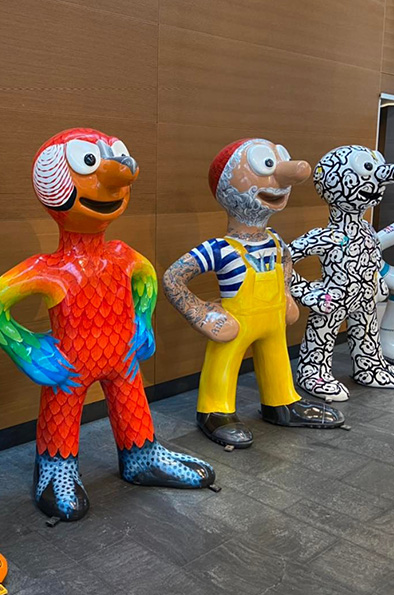 3 Morph statues decorated as a parrot, fisherman and abstract designs 